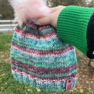 Hand knit beanie with a faux fur pom pom